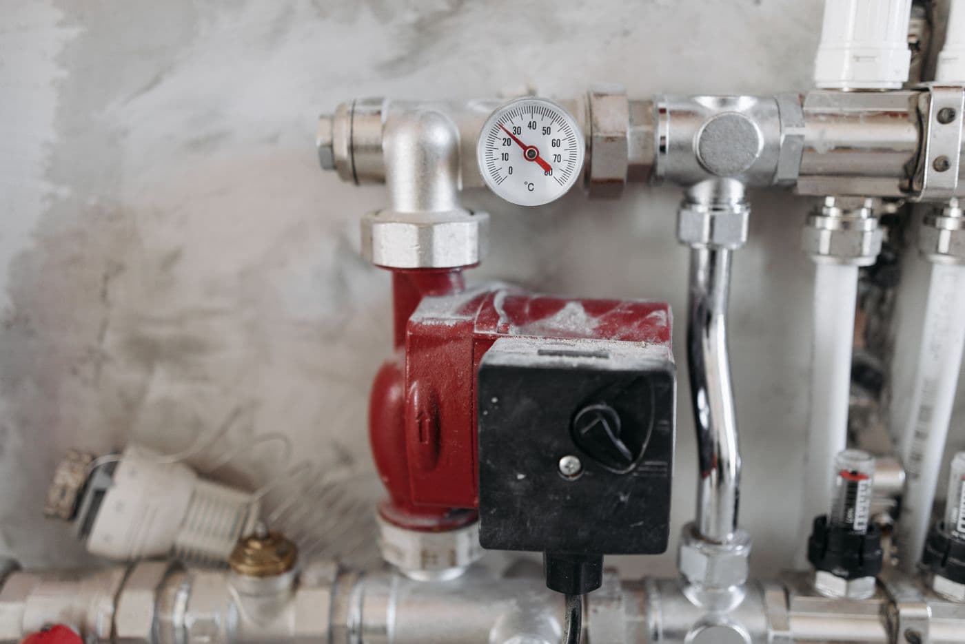 Pipe manifold with a dial thermometer and a circulator pump